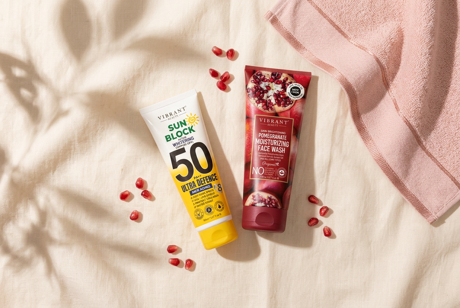 Vibrant Beauty Sun Block SPF 50 and Pomegranate Moisturizing Face Wash on cream linen, everyday skincare essentials